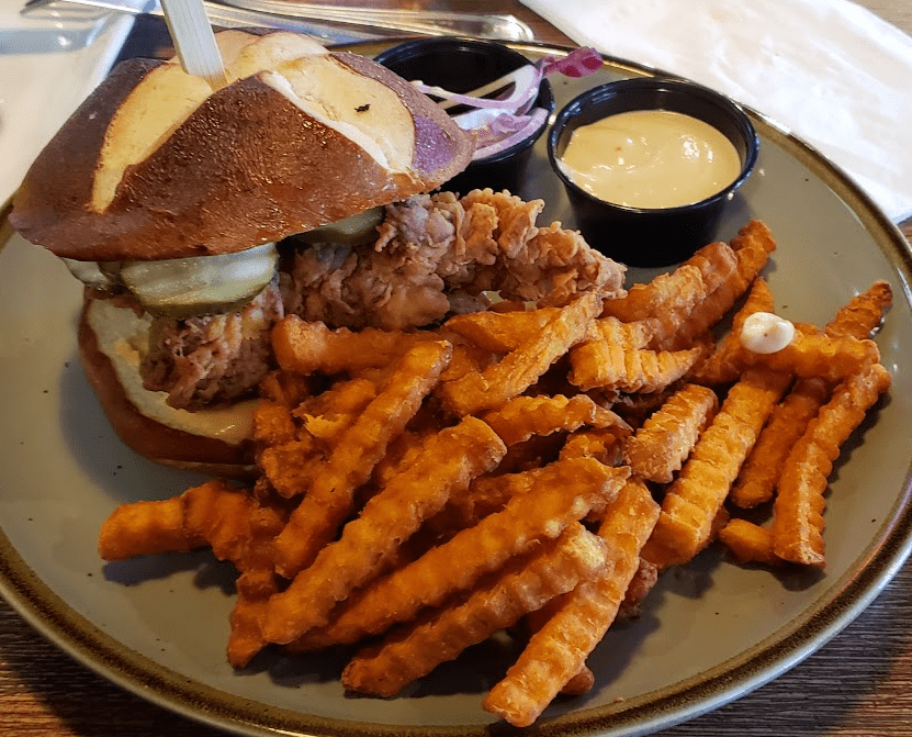 Logan's chicken sandwich on pretzel bun with fries